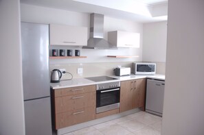 Executive Apartment, 2 Bedrooms | Private kitchen | Full-size fridge, dishwasher, highchair, cookware/dishes/utensils