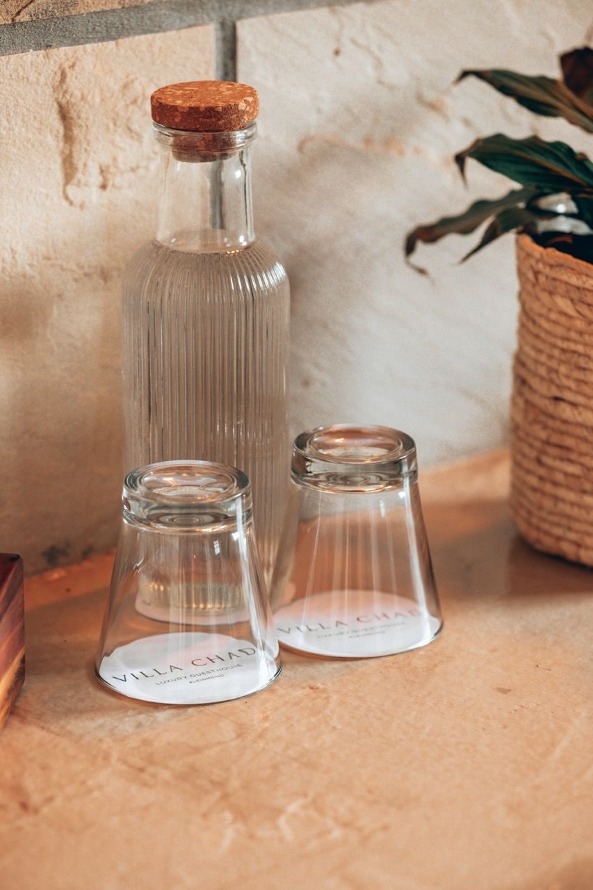 Three glass bottles with cork stoppers on a textured surface.