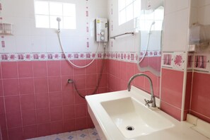 A bathroom with a white sink, pink tiles, a shower, and a window. - I - Talay (Rayong)