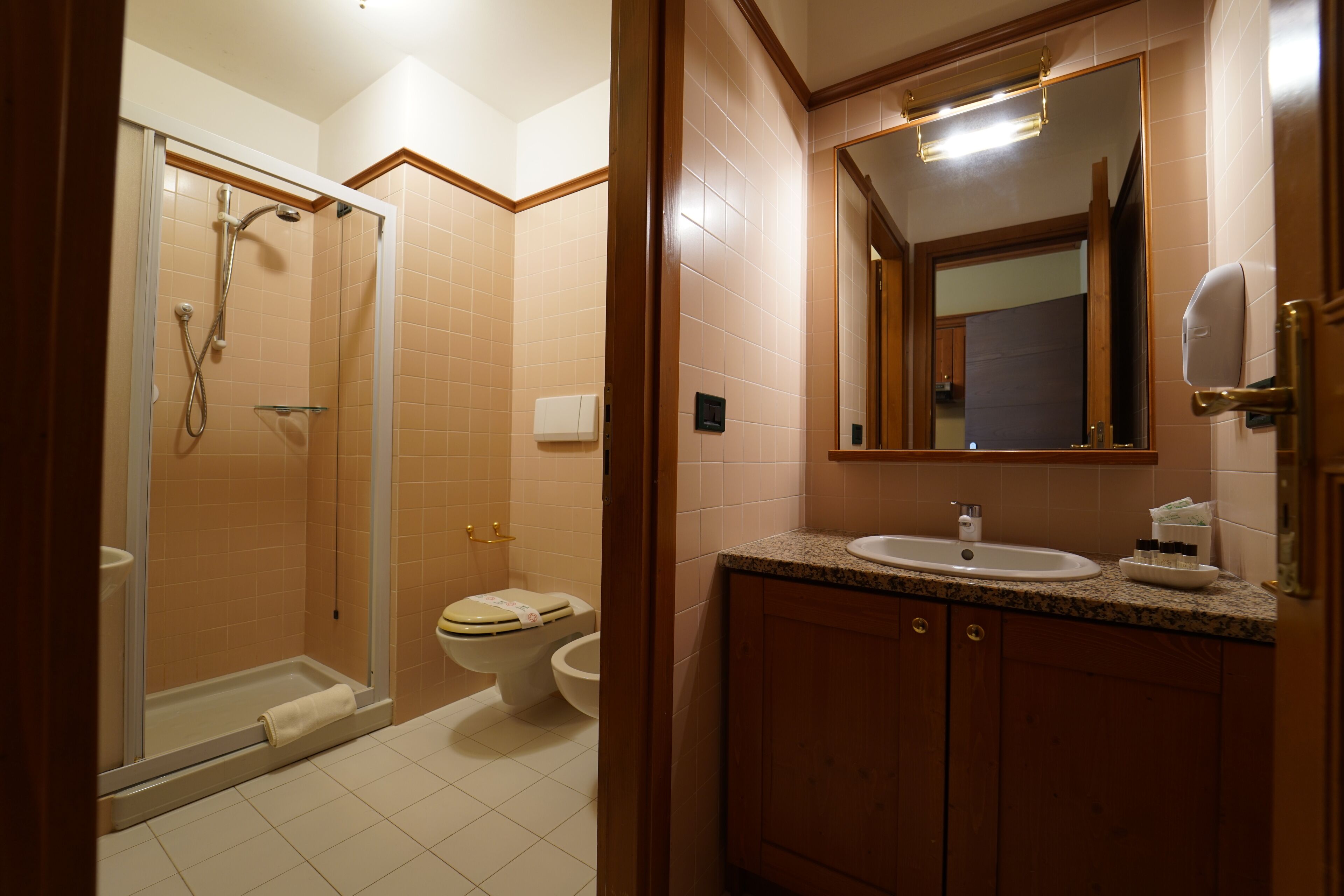 A bathroom with a shower, toilet, and sink.