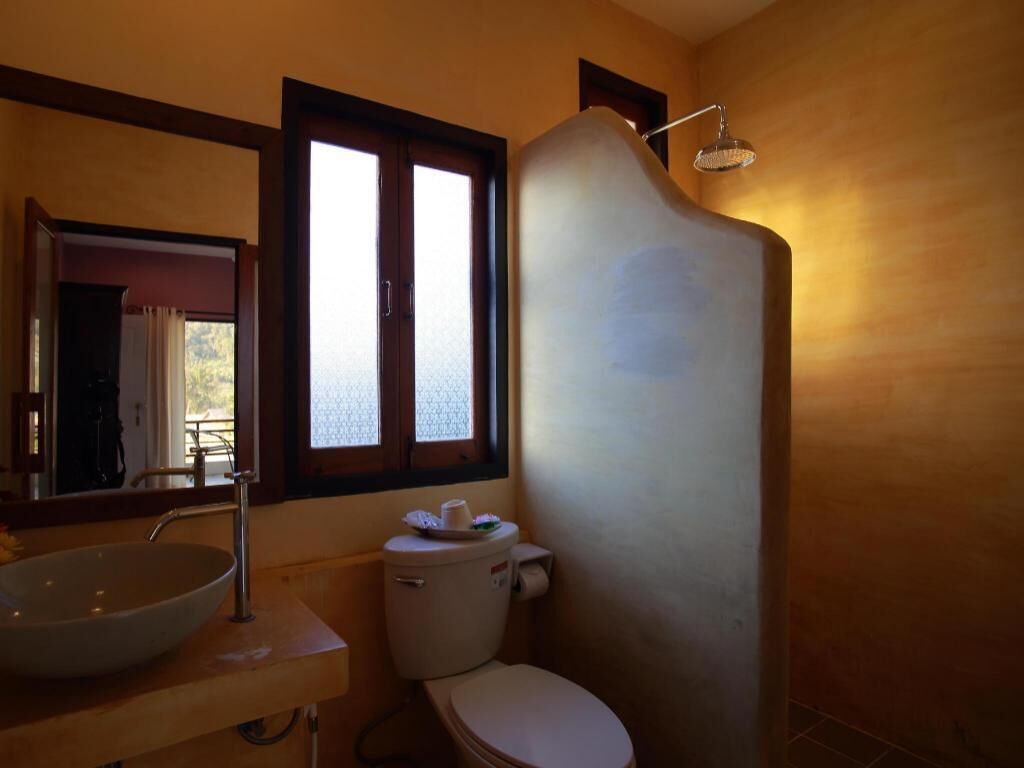 A bathroom with a sink, toilet, and shower.