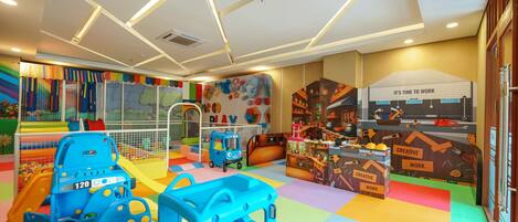 A children's play area with colorful play structures, a slide, and a playhouse.