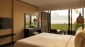 A hotel room with a bed, a desk, a TV, and a view of the ocean. - Ekho Surf (Bentota)
