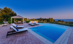 A swimming pool with lounge chairs and a gazebo. - Frido Luxury Villa (Zakynthos)