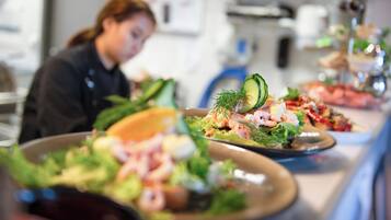 Buffet com diversos pratos, incluindo frutos do mar e saladas.