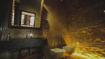 Exclusive Room, 1 King Bed, Courtyard View (Petra) | Bathroom | Combined shower/tub, deep soaking tub, rainfall showerhead