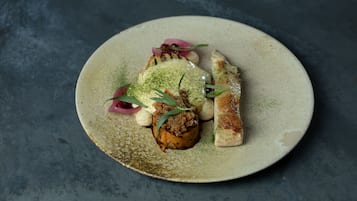 A plate with food items on a textured surface.