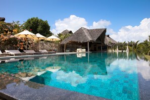 Outdoor pool, an infinity pool, pool umbrellas, sun loungers