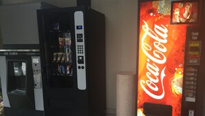 A vending machine with a Coca-Cola logo and a digital display.