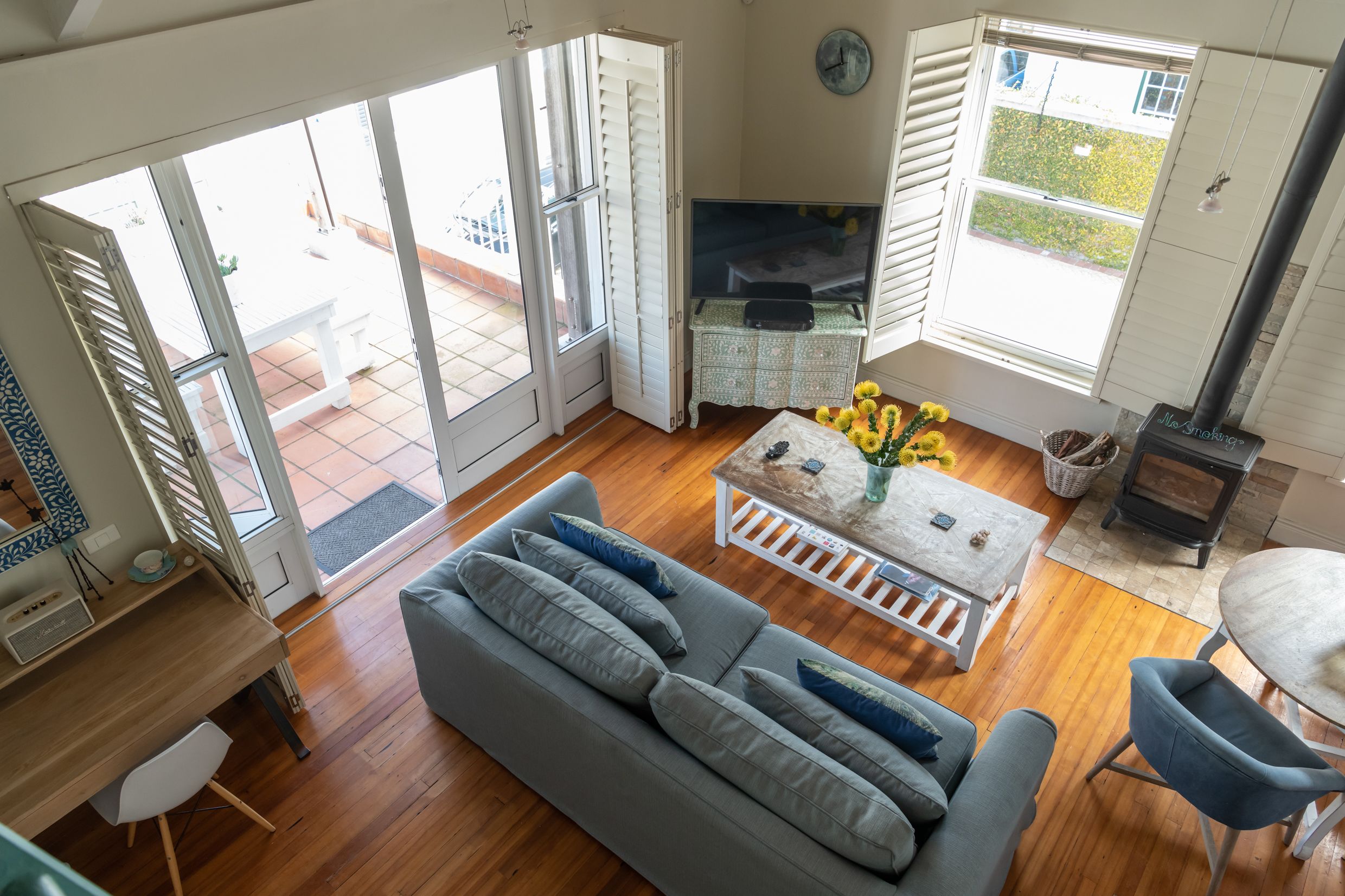 A spacious living area with a sofa, coffee table, and a fireplace.