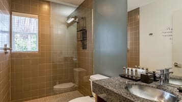 A bathroom with a shower, toilet, and sink.