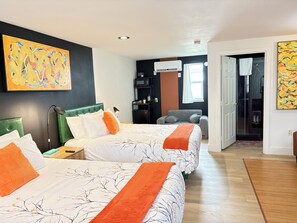 A hotel room with two beds, a desk, a chair, a microwave, and a window. - Riverwalk Park Inn (Chelan)