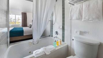 Bañera con ducha, artículos de tocador de diseñador, secador de pelo