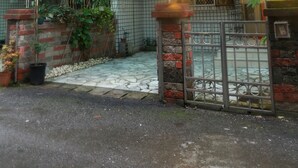 A traditional Japanese-style entrance with a tiled facade, a covered entranceway, and a sign indicating a public bath.