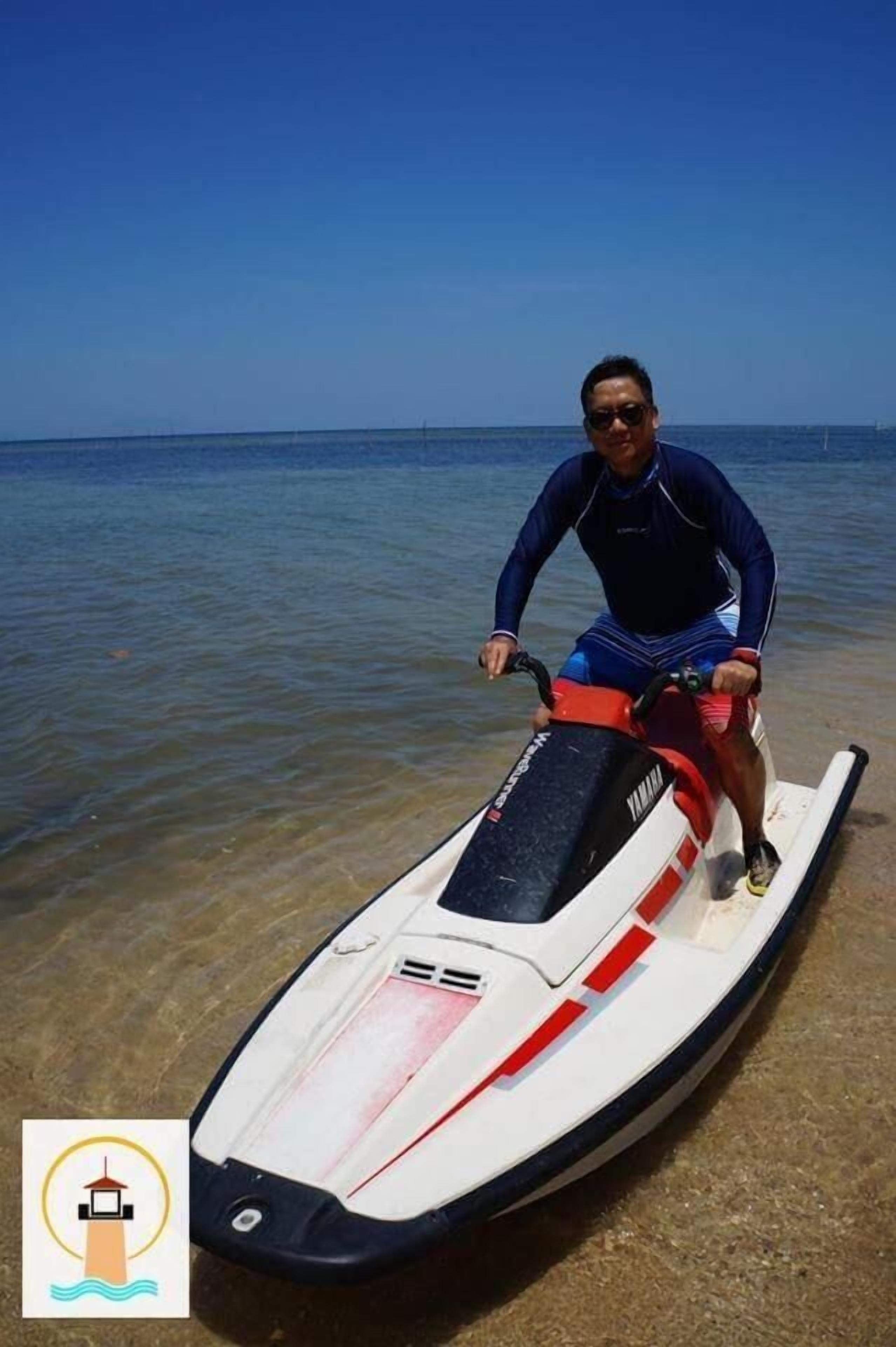 A person on a jet ski near a body of water.