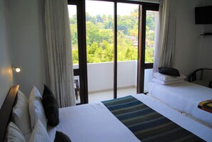 Deluxe Triple Room with Balcony | Minibar, in-room safe, desk, laptop workspace