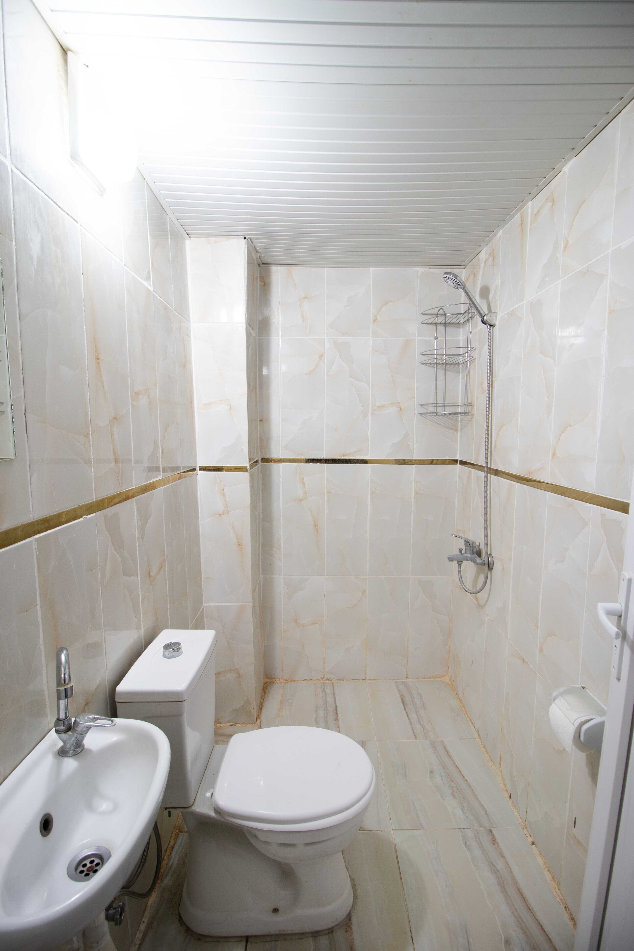A bathroom with a sink, toilet, and shower.