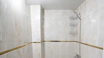 A bathroom with a sink, toilet, and shower.