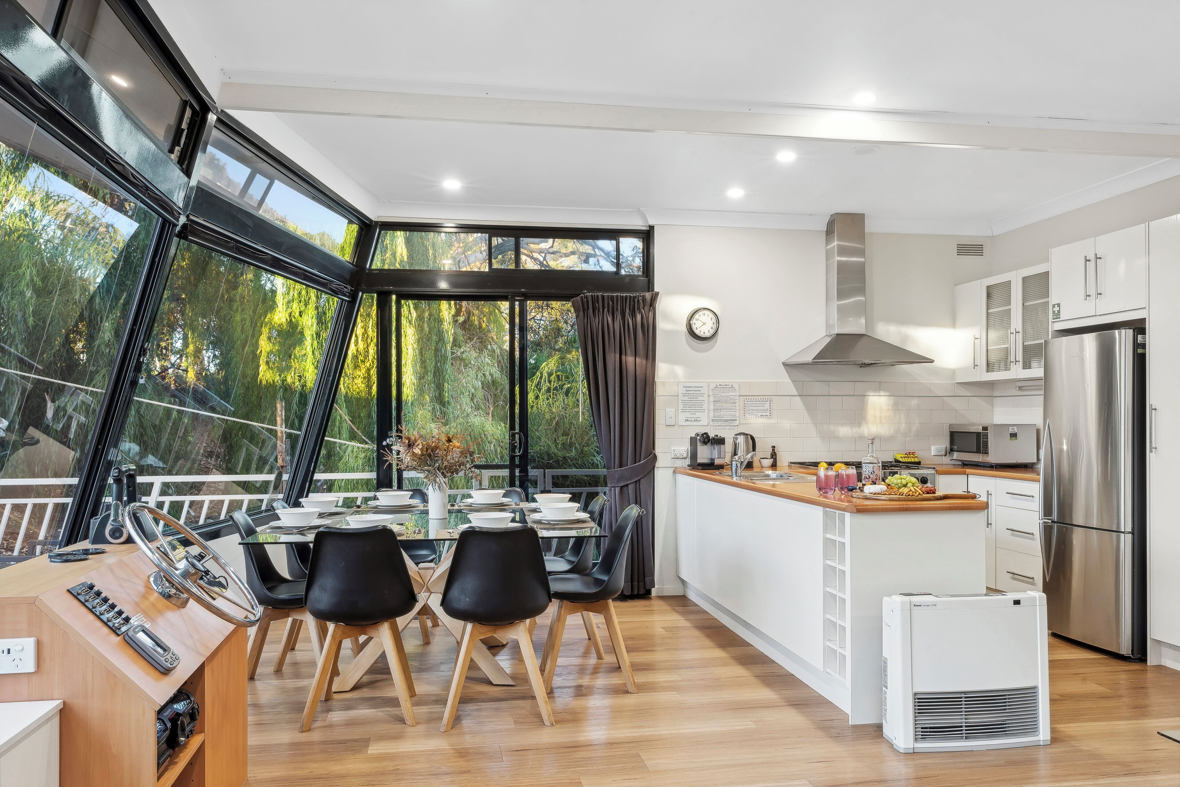 Boats and Bedzzz - Moving Waters Houseboat (Moored Accommodation) | Living area | 65-inch Smart TV with digital channels, TV, books