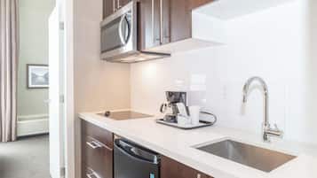 A modern kitchen with stainless steel appliances, a dishwasher, and a sink.