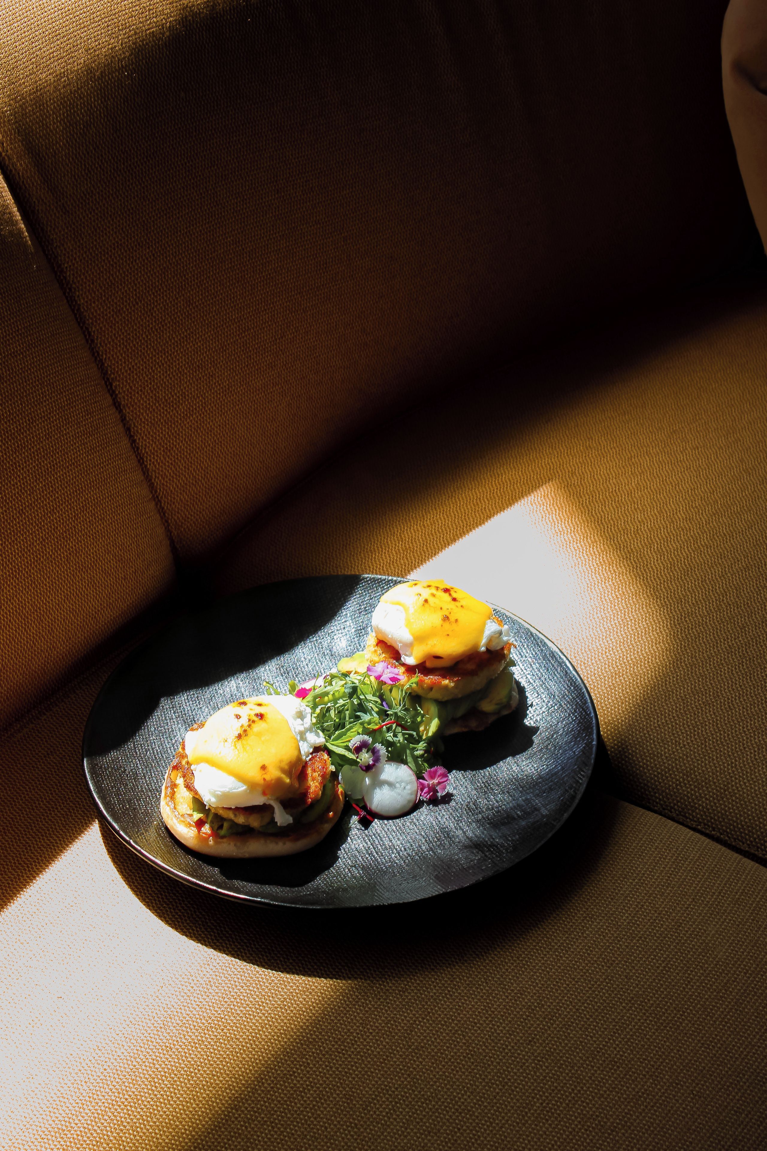 A plate of food on a dark surface, possibly a table or counter, with a brown textured background.