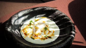 A plate of food on a dark stone surface.