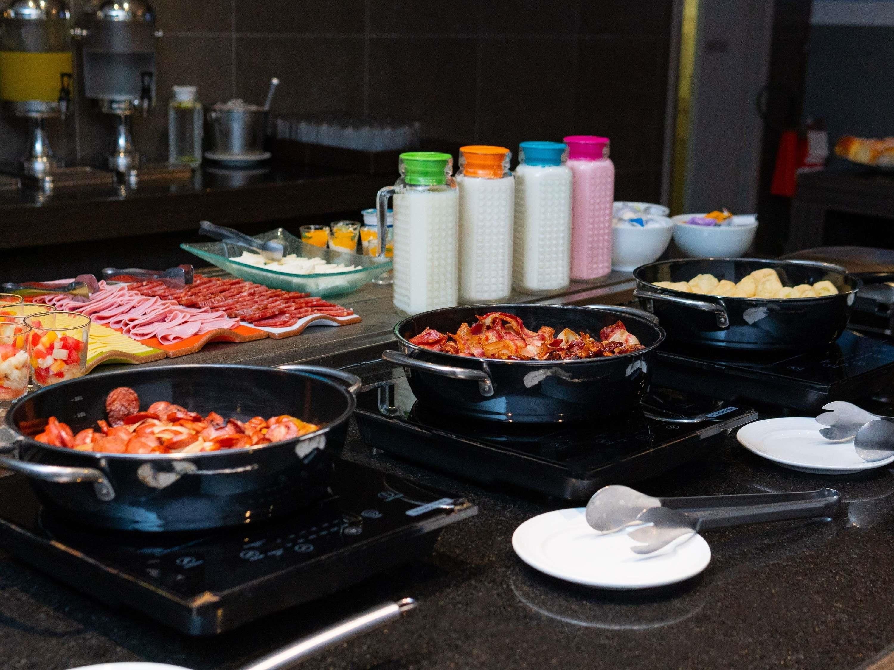 A buffet with various food items and condiments.