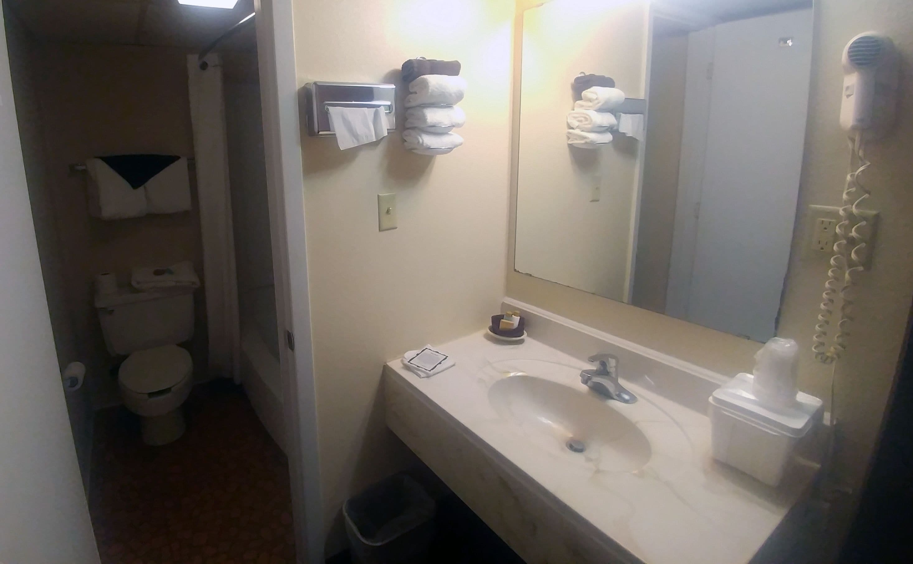 bathtub, designer toiletries, towels, soap