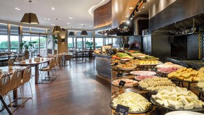 A buffet area with various food options and a seating area with tables and chairs. - Radisson Blu Hotel Istanbul Ottomare (Istanbul)