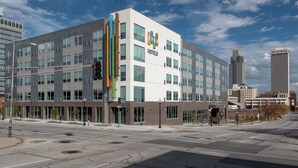 A multi-story hotel with a modern design, featuring large windows and a prominent sign. - EVEN Hotel Omaha Downtown - Old Market by IHG (Omaha)