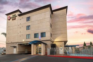 A Best Western Plus hotel with a modern facade, a covered entrance, and a swimming pool area. - Best Western Plus Gardena Inn & Suites (Gardena)