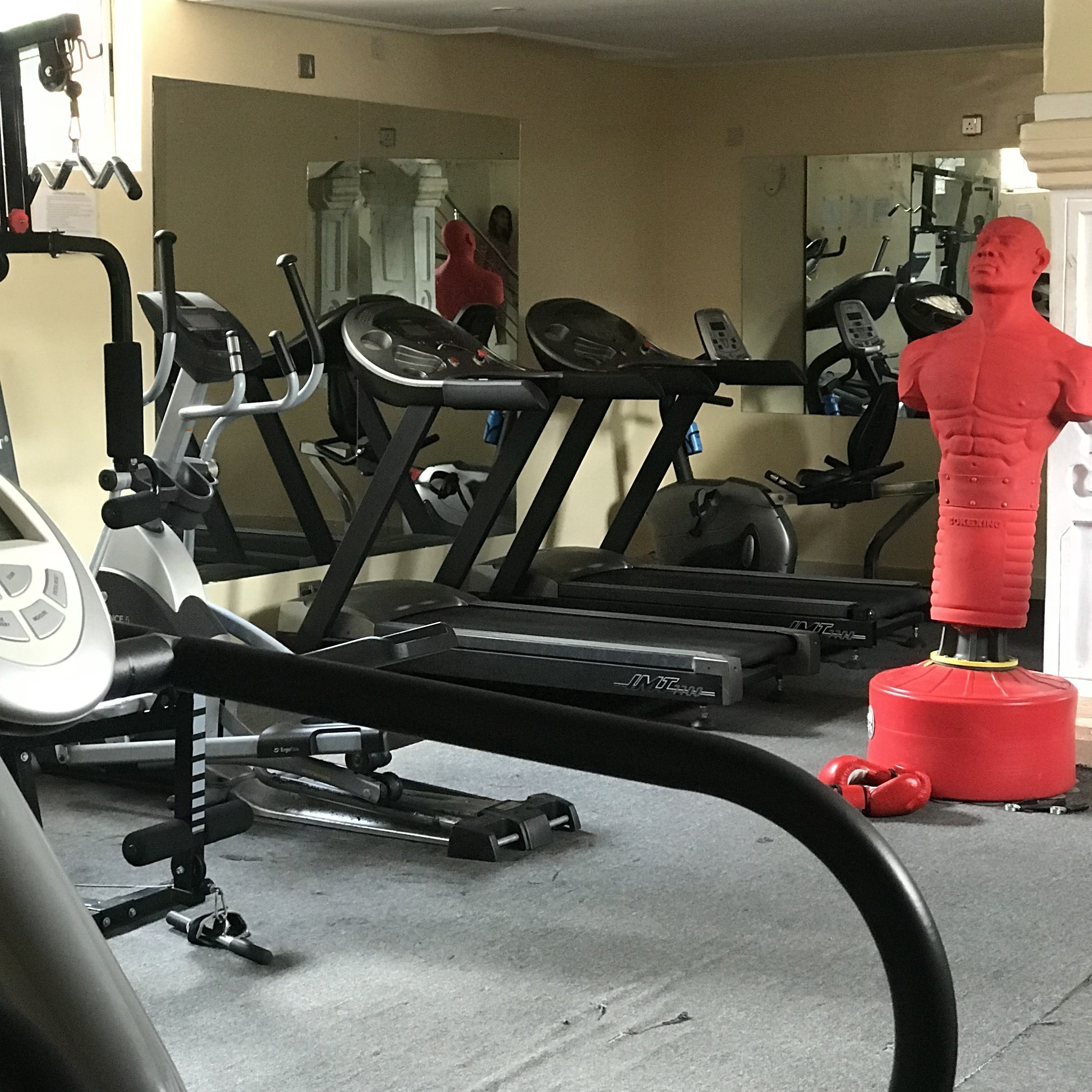 A gym with exercise equipment including treadmills and a stationary bike.