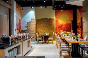 A restaurant with a brick wall, wooden tables, and chairs. - Best Western Plus Hotel Subic (Olongapo)