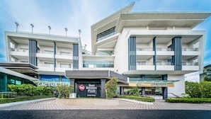 A modern hotel with multiple floors, a prominent entrance, and a well-maintained outdoor area. - Best Western Plus Hotel Subic (Olongapo)