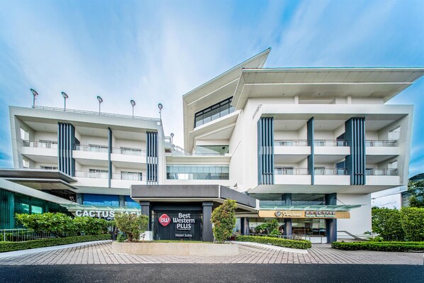 A modern hotel with multiple floors, a prominent entrance, and a well-maintained outdoor area. - Best Western Plus Hotel Subic (Olongapo)