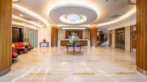 A spacious lobby with a reception desk, seating area, and a chandelier. - Best Western Plus Hotel Subic (Olongapo)