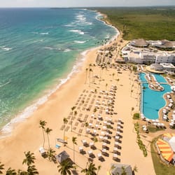On the beach, white sand, beach cabanas, sun loungers