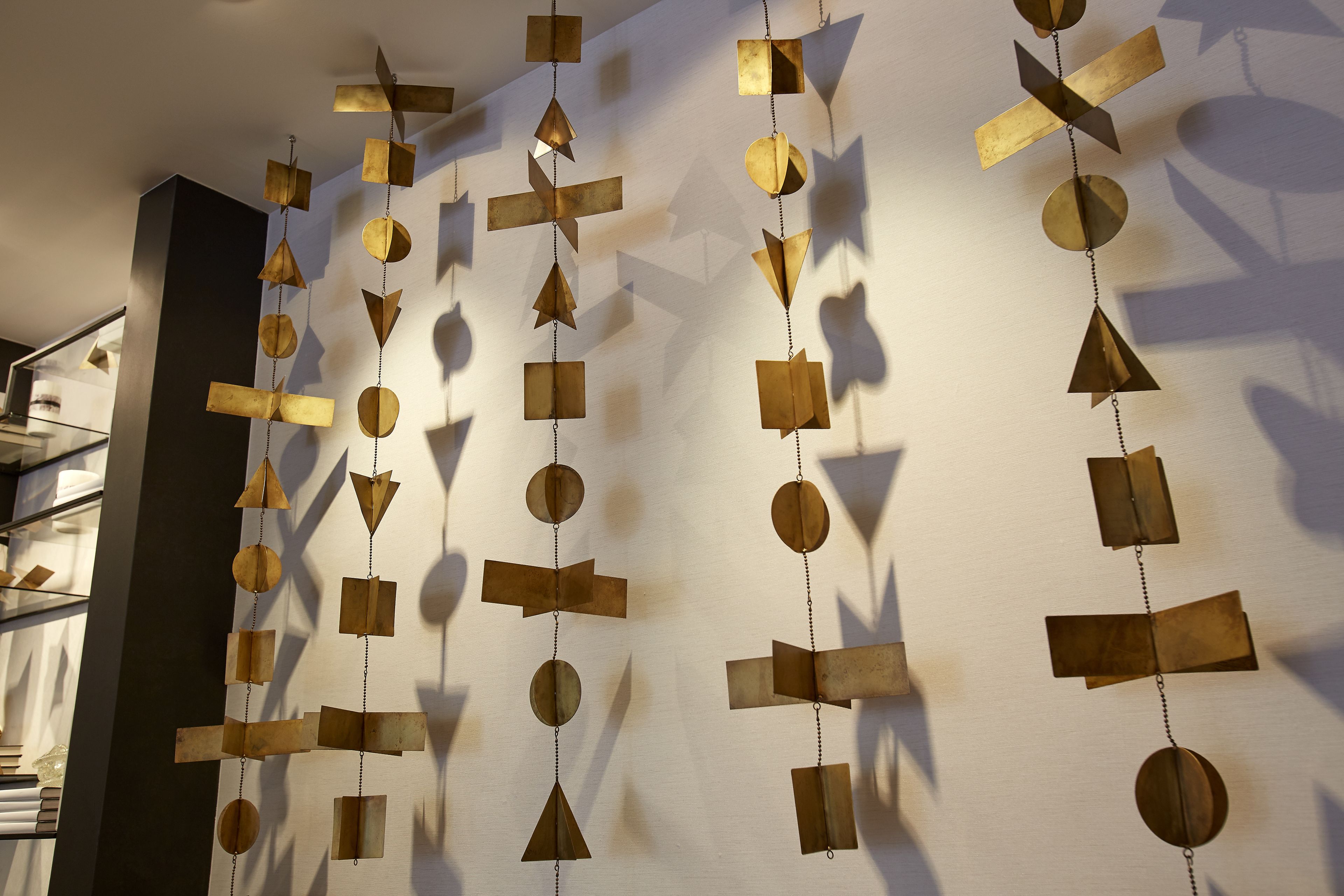 A wall with geometric metal art installations.