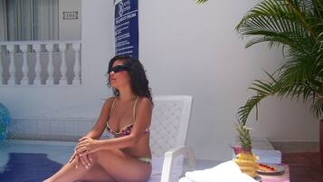 Relax by the pool with a lounge chair and towels at hand.