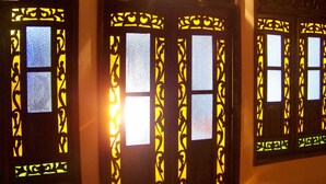 A set of doors with intricate black designs and glass panels.