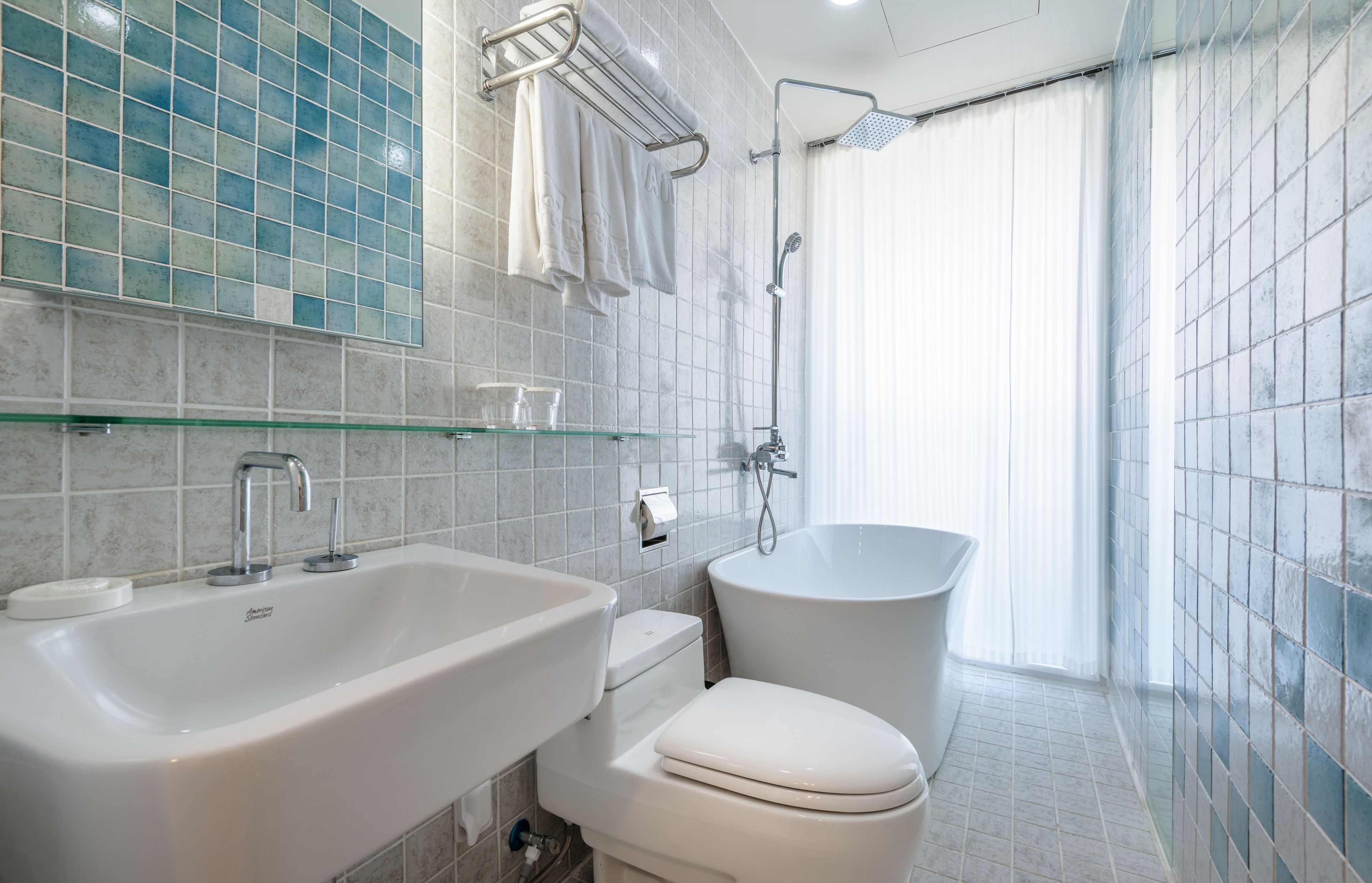 A modern bathroom with a large sink, toilet, and bathtub.