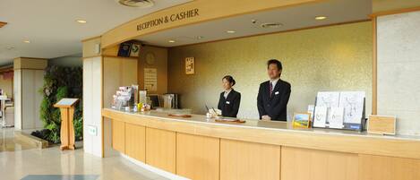 A reception desk with a sign reading "Reception & Cashier".