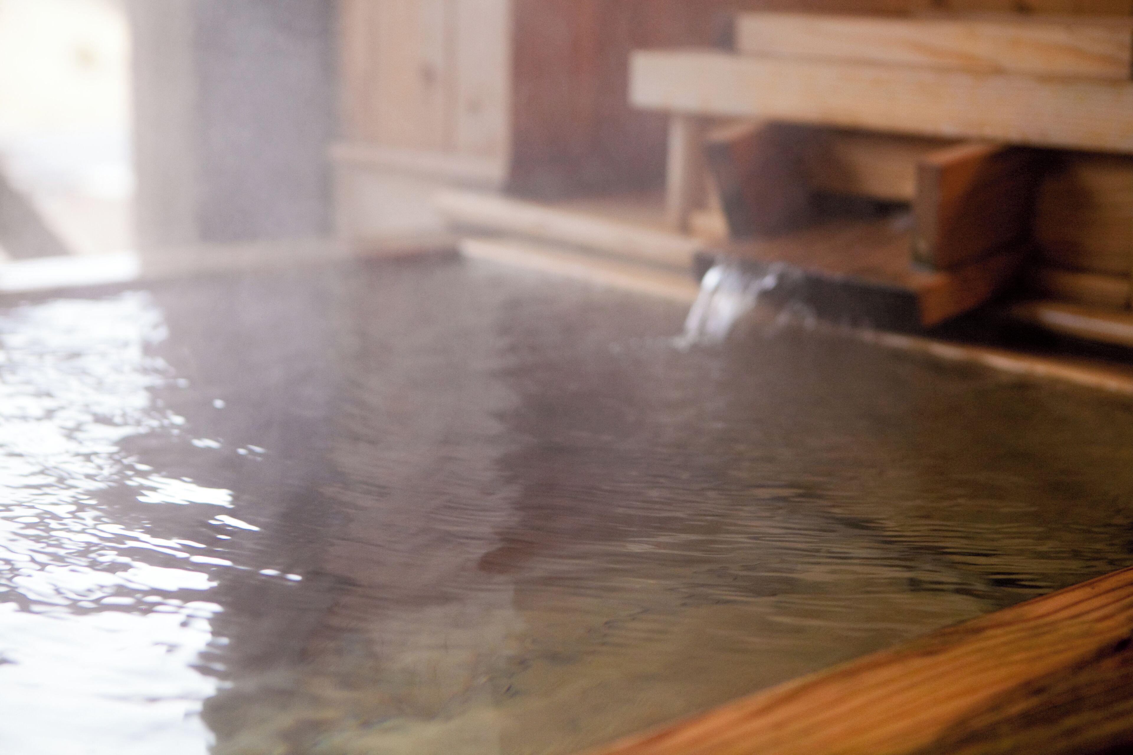 A wooden interior with a large, reflective water feature.