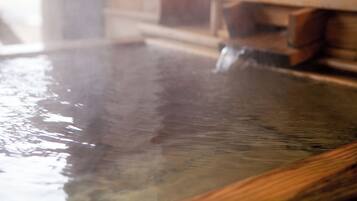 A wooden interior with a large, reflective water feature.