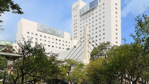 A modern building with multiple floors and a prominent glass section on the upper levels. - Hotel Fujita Fukui (Fukui)