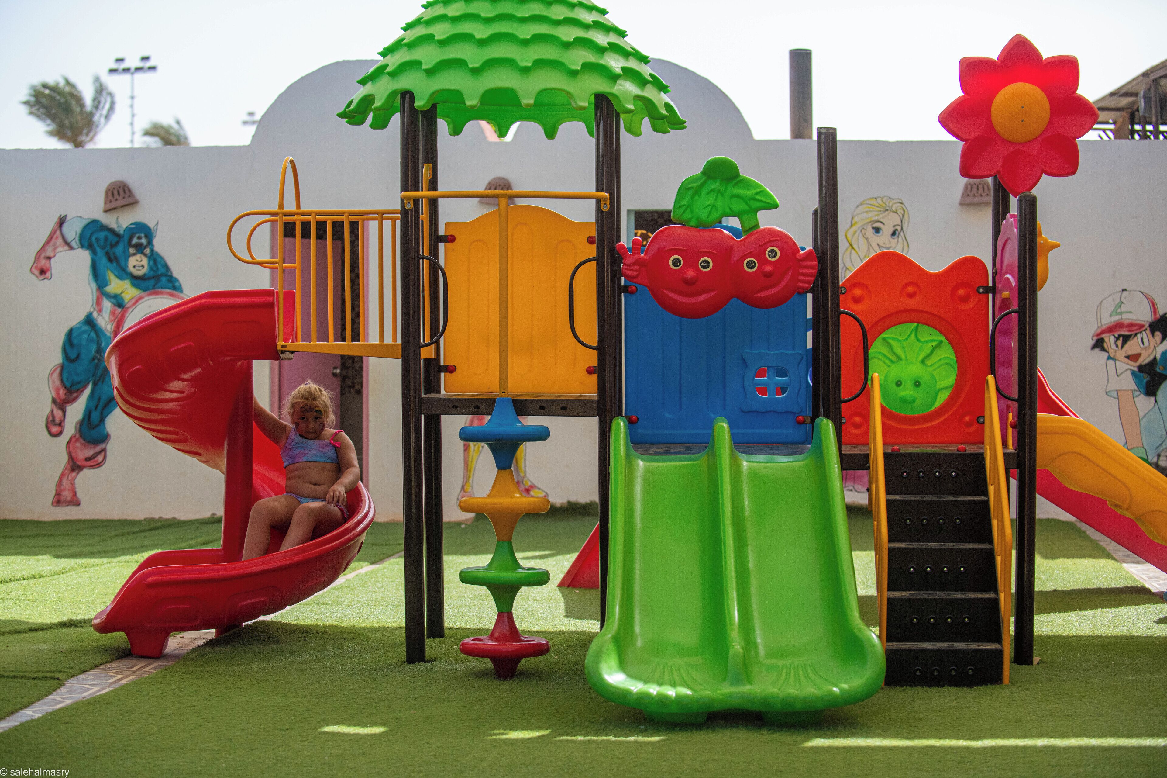 A children's playground with slides and climbing structures.
