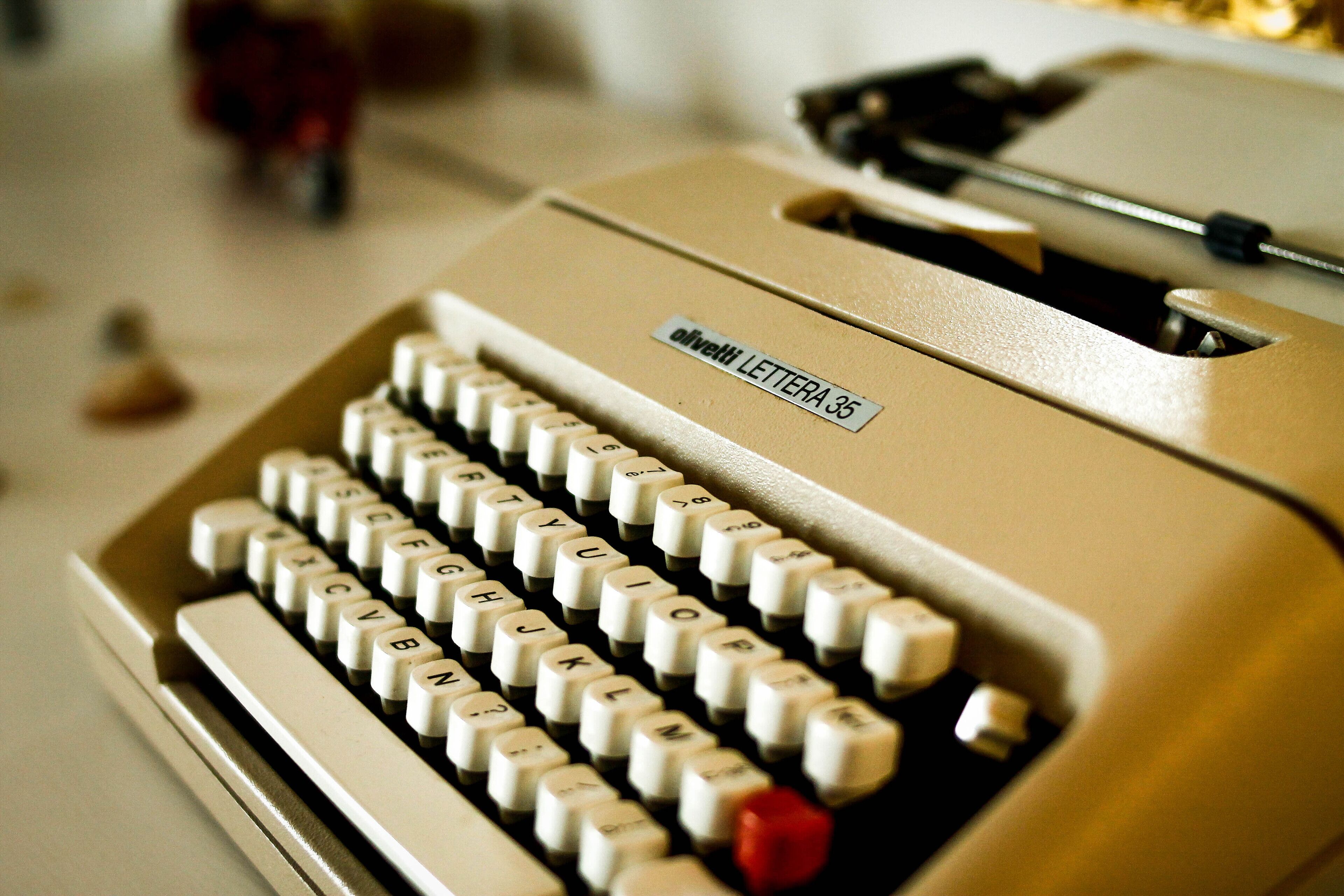 A vintage Olivetti Lettera 35 typewriter with a beige body and white keys.