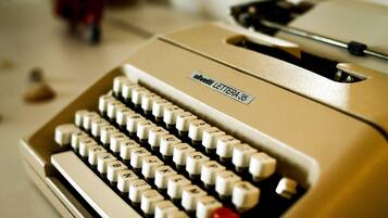 A vintage Olivetti Lettera 35 typewriter with a beige body and white keys.