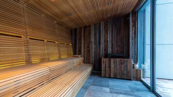 Un interior moderno con un banco de madera, una recepción y ventanas amplias.