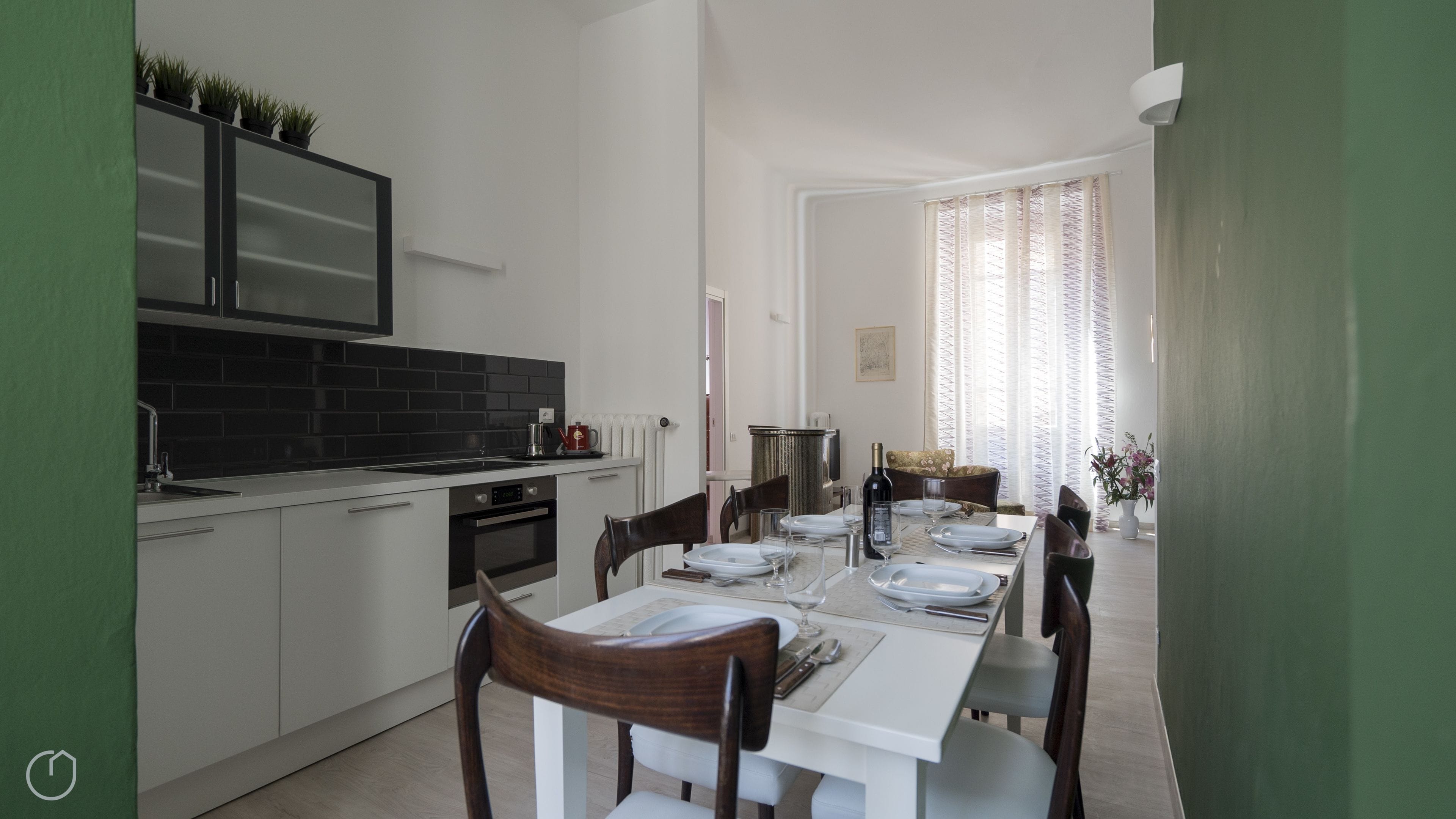 A modern kitchen with a dining area.